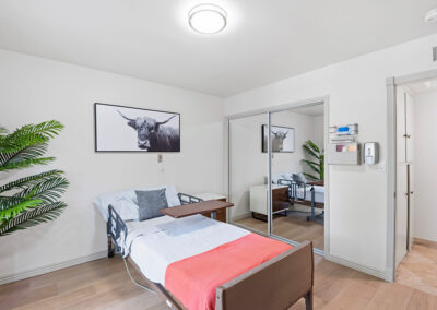 A bedroom with a closet at Newport Heights