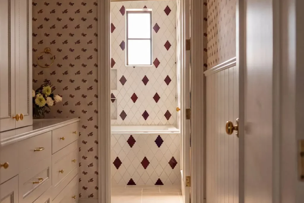 The view into a bathroom with red and white patterned tile