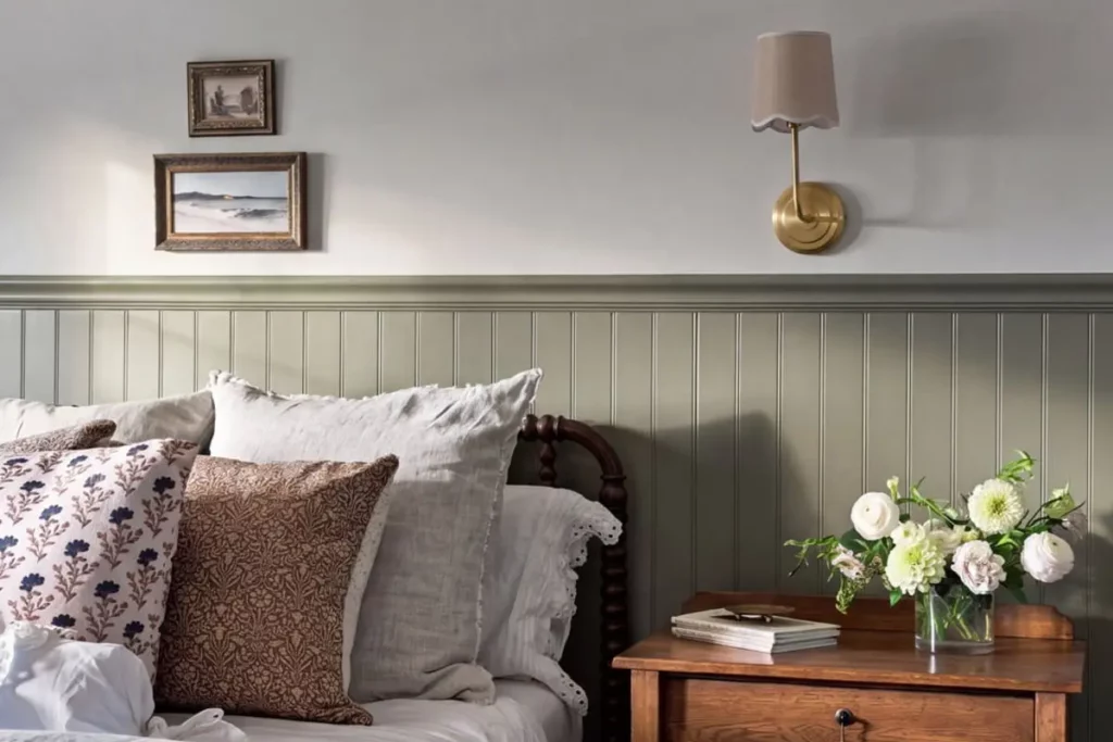 Nightstand next to a bed with multicolored throw pillows