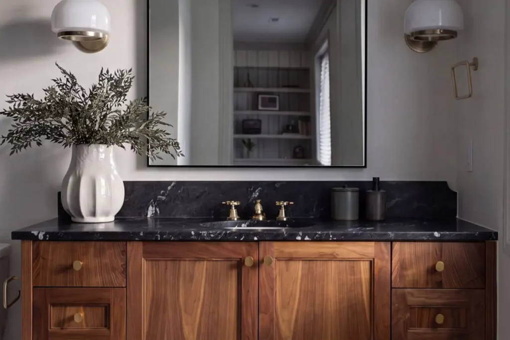 Bathroom sink with a large mirror and potted plant