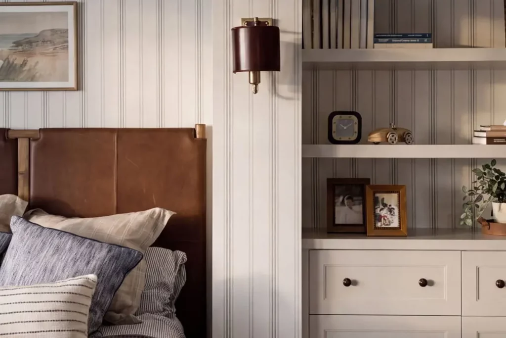A bed next to built in bookcases