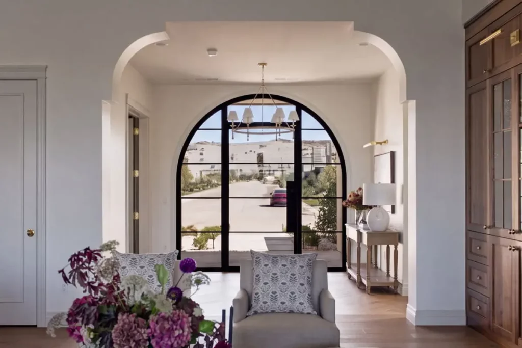 A sitting area next to a large arched glass door