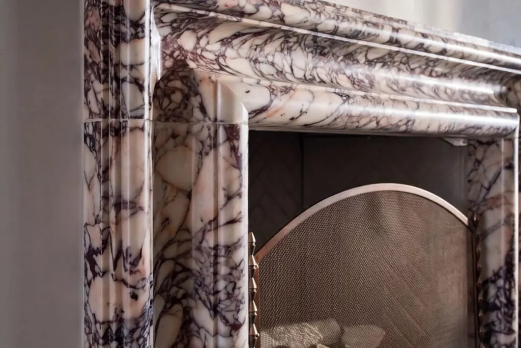 A close up of a marble-lined fireplace