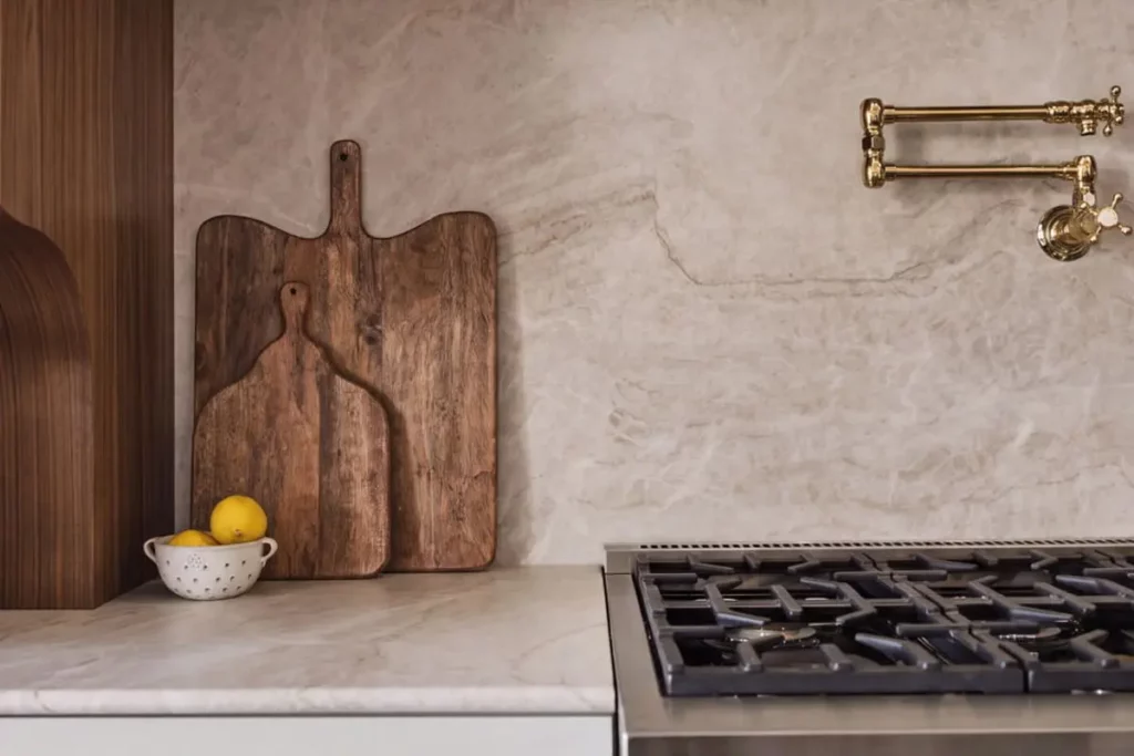 Granite countertops with wooden cutting boards and a brand new stovetop