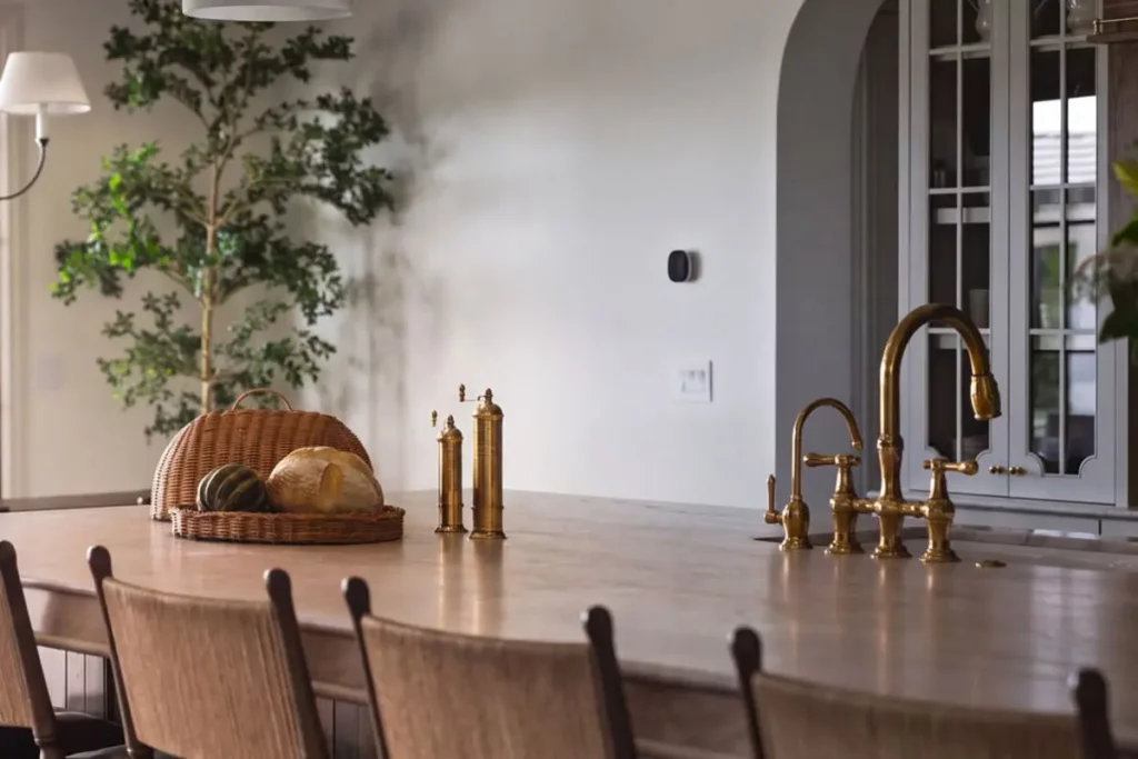 Kitchen island with a built in sink and wooden bar chairs