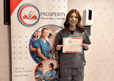 A nurse with her certificate of graduation at Prosperity