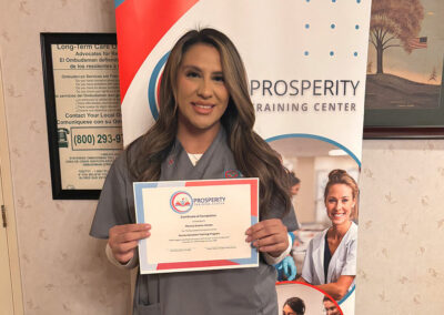 A nurse with her certificate of graduation at Prosperity