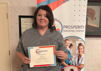 A nurse with her certificate of graduation at Prosperity