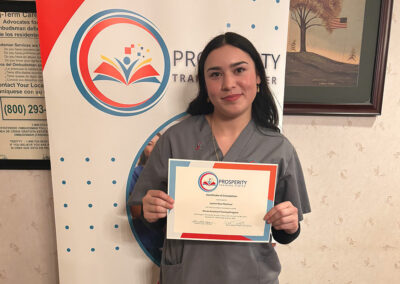 A nurse with her certificate of graduation at Prosperity