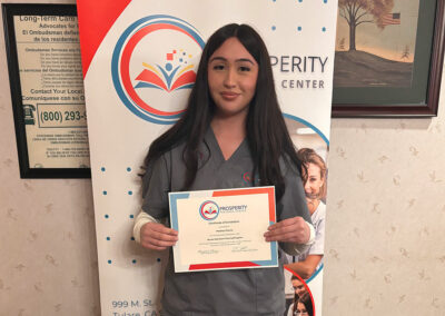 A nurse with her certificate of graduation at Prosperity