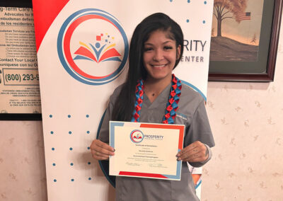 A nurse with her certificate of graduation at Prosperity