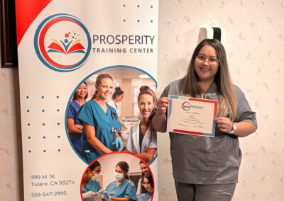 A nurse with her certificate of graduation at Prosperity
