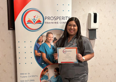 A nurse with her certificate of graduation at Prosperity