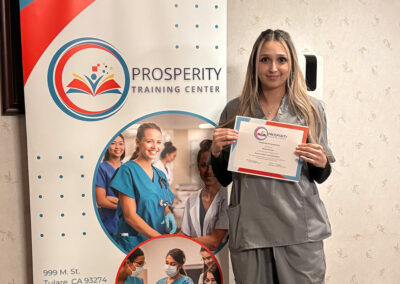 A nurse with her certificate of graduation at Prosperity