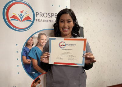 A nurse with her certificate of graduation at Prosperity