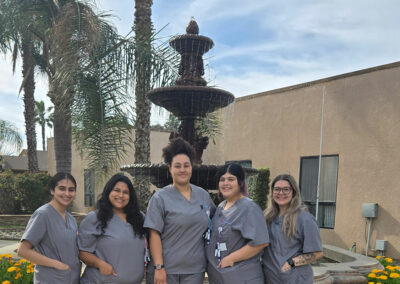 A group of Prosperity graduates standing in front of a fountain