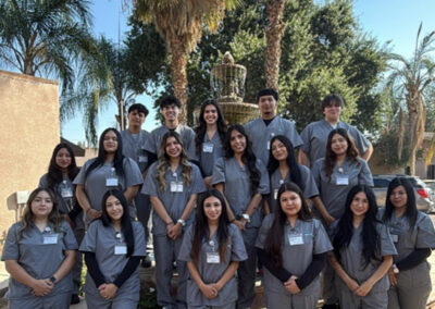 A group of Prosperity graduates standing in front of a fountain