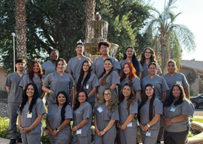 A group of Prosperity graduates standing in front of a fountain