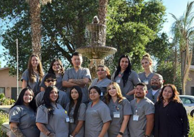 A group of Prosperity graduates standing in front of a fountain