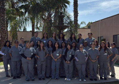 A group of Prosperity graduates standing in front of a fountain