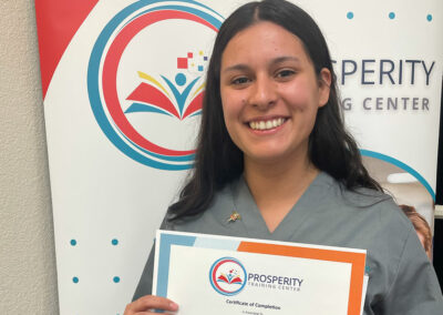 A nurse with her certificate of graduation at Prosperity
