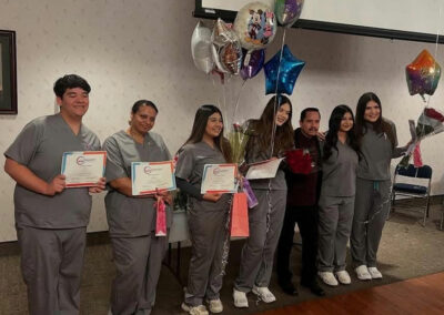 A group of Prosperity graduates standing with their certificates