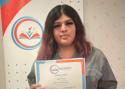A nurse with her certificate of graduation at Prosperity