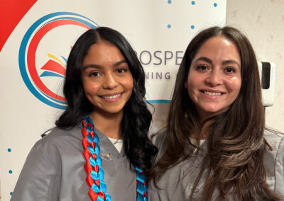 Two nurses smiling together at their graduation of Prosperity