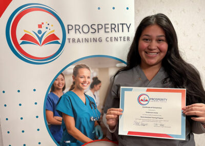 A nurse with her certificate of graduation at Prosperity