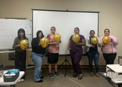 A group of Prosperity graduates holding balloons