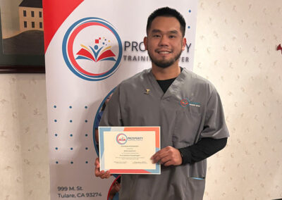 A nurse with her certificate of graduation at Prosperity