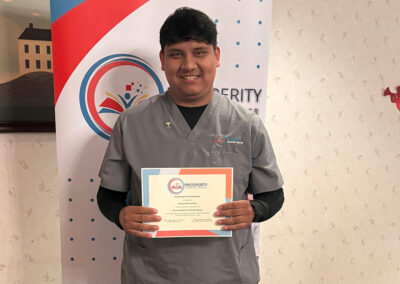 A nurse with her certificate of graduation at Prosperity