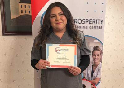 A nurse with her certificate of graduation at Prosperity