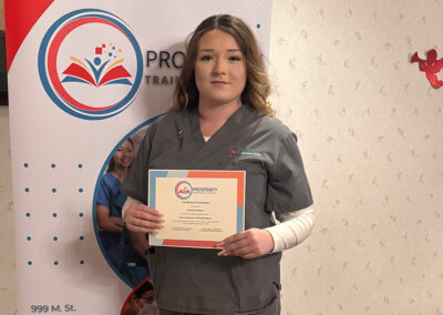 A nurse with her certificate of graduation at Prosperity
