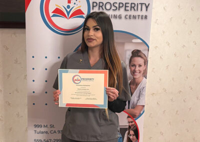 A nurse with her certificate of graduation at Prosperity