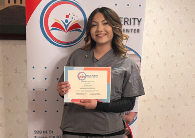 A nurse with her certificate of graduation at Prosperity