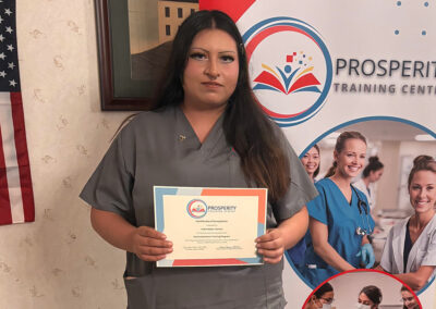 A nurse with her certificate of graduation at Prosperity