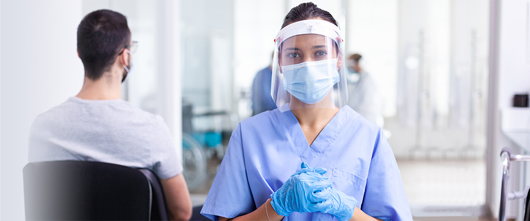 yolo-1080x450-49 A nurse in a shield and mask.
